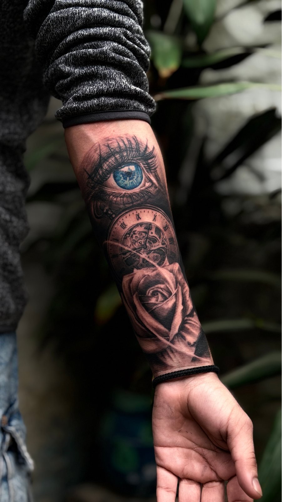 Realistic eye and rose sleeve tattoo